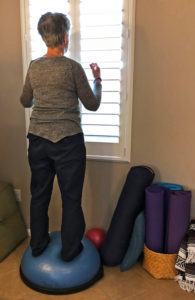 Joyce balancing move on BOSU while cleaning