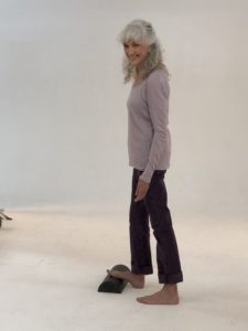 Lora doing traditional barefoot calf stretch for restless legs syndrome relief