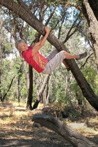 Joan climbing a tree