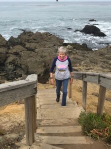Joan climbing steps at the beach