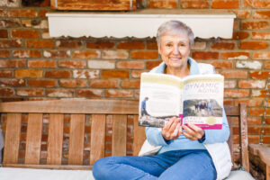 Joan in a Swing with book Dynamic Aging